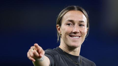 Lucy Bronze points and smiles