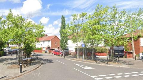 Google Maps image of Borland Avenue showing houses and several parked cars.