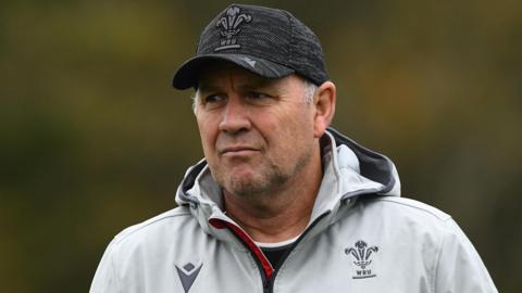 Wayne Pivac in Wales kit and a baseball cap