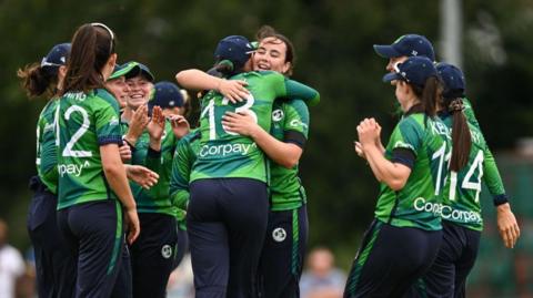 Jane Maguire of Ireland is congratulated by teammates after bowling the wicket of Harshitha Samarawickrama of Sri Lanka.