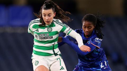 Amy Gallacher of Celtic runs with the ball while under pressure from Oriane Jean-Francois