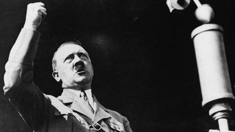 Adolf Hitler raising his fist at the Berlin International Auto Show