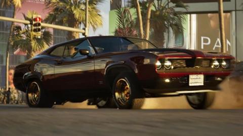 An image from the video game Mindseye showing a car  racing through the streets of a US city. There are palm trees in the background and buildings. The car is black and resembles a Ford Mustang slightly. 