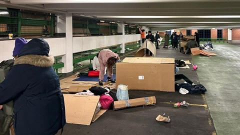 Volunteers are assembling various cardboard boxes in the covered carpark at Freshney Place.