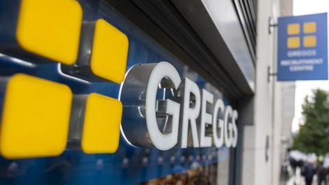 A close-up of a GREGGS sign.