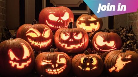 Eight differently carved pumpkins lit up in a doorway