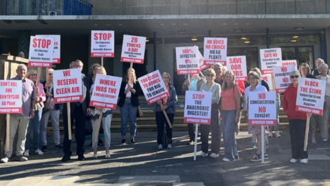 A group of residents gathered on Durham County Council steps holding placards reading "Stop the anaerobic digester" and "No consultation No consent".