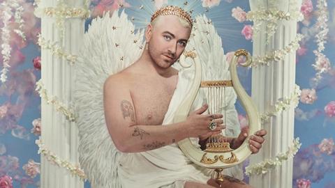 Image shows artwork featuring Sam Smith playing a harp with angel wings and a crown, surrounded by floral angelic items