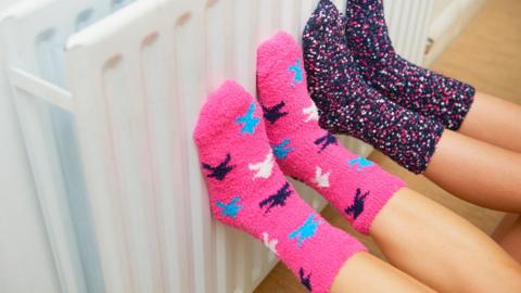 Colourful socks warming on a radiator