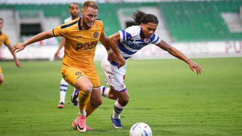 Cameron Norman battles for the ball in Newport County's friendly against Reading