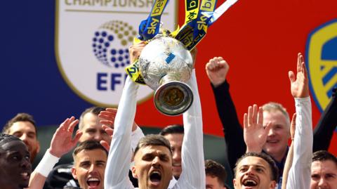 Leeds United players celebrating with Championship trophy