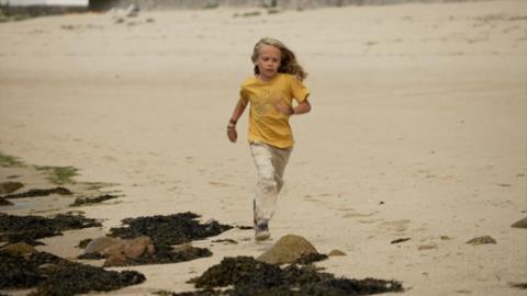 Boy running on beach
