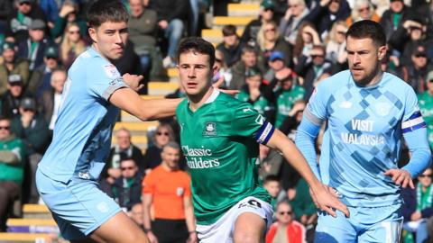 Adam Randell of Plymouth Argyle (centre) in action against Cardiff City in the Championship