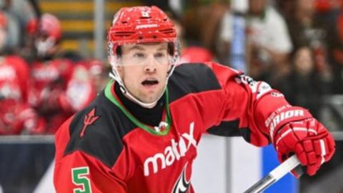 Ben Davies of Cardiff Devils with stick in hand skates up the ice