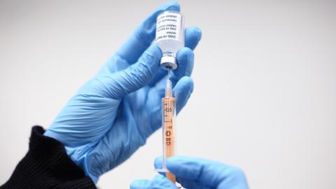 Vaccine being drawn by syringe 