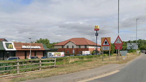 McDonald's branch off Lincoln Road with a reduce speed now roundabout sign