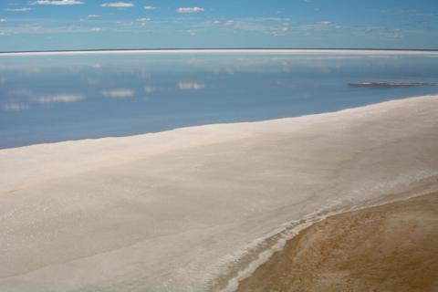 Lake Eyre with water surrounded by a dry landscape