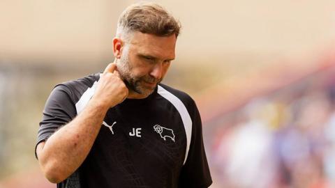 A downcast looking John Eustace in a black Derby County training top