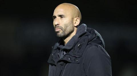 Lee Grant wearing a black coat