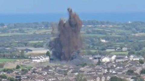 Explosion in Newtownards, County Down, large black flume above housing estate