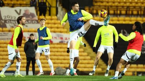 Port Vale players warm up at Vale Park before their League Two game against Crewe Alexandra 