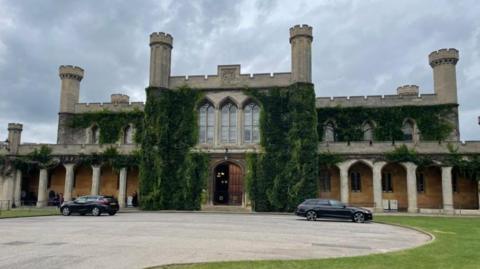 The exterior of Lincoln Crown Court with greenery growing up the walls, columns and turrets