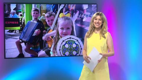 Jenny in the studio with children in the screen
