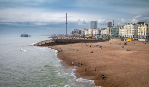 Brighton beach, with a blue sea on the left and pebbles on the right