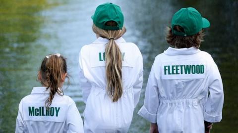 Poppy McIlroy, daughter of Rory McIlroy, Iris Lowry, daughter of Shane Lowry, and Frankie Fleetwood, son of Tommy Fleetwood of England, look on while at the ninth hole during the Par Three Contest