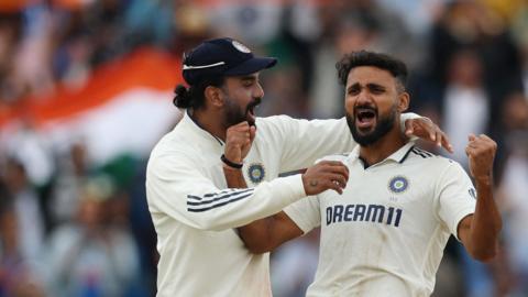 Akash Deep celebrates a wicket with KL Rahul, left