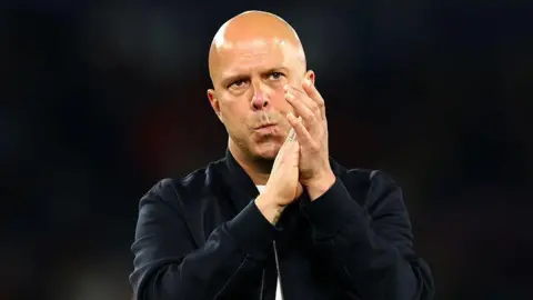 Liverpool boss Arne Slot looks glum after the loss to PSG