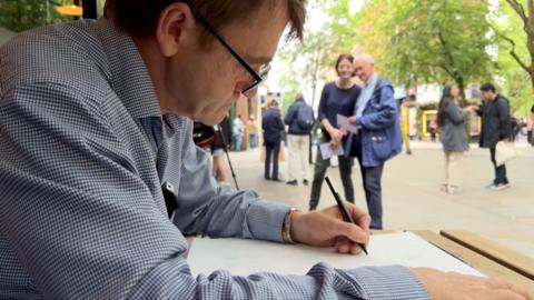 David Bedford drawing outside a London restaurant