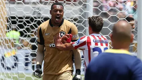 John Victor Maciel Furtado celebrates after making a save against Atletico Madrid.