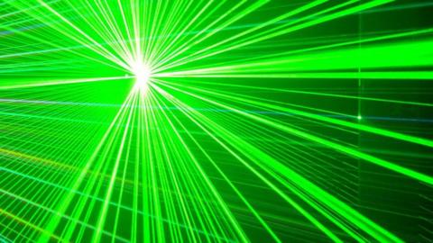 A dark background with multiple bright green laser beams.