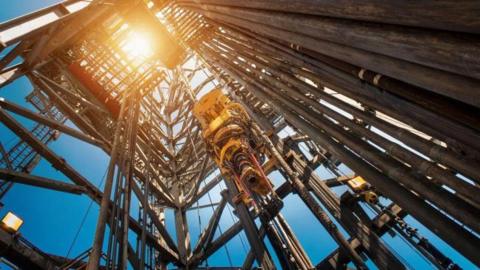 A large oil rig, pictured from beneath.
