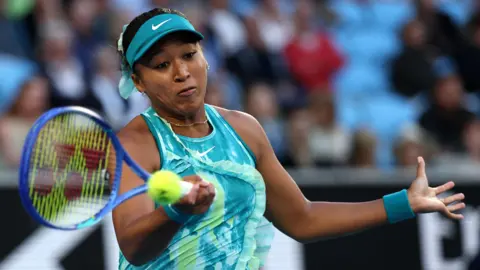 Naomi Osaka hits a forehand