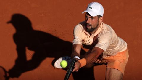 Novak Djokovic hits a backhand