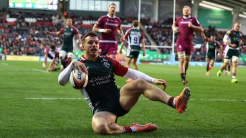 Leicester's Adam Radwan slides over the try-line to score