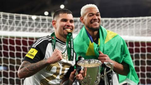 Bruno Guimaraes and Joelinton holding the EFL Cup