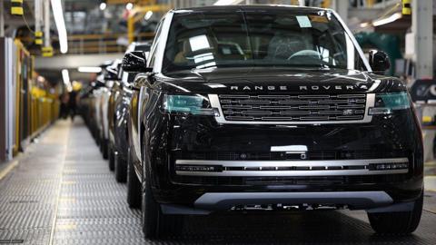 A line of Range Rovers on a production line in a UK factory