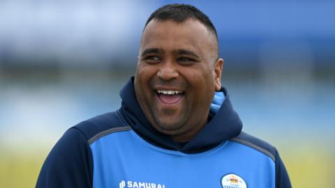 Samit Patel laughs while warming up for Derbyshire
