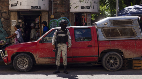 A member of the National Guard stands guard in the street after the killing of Alejandro Arcos, who had just taken office as the mayor of Chilpancingo, the capital of Mexico's state of Guerrero, on 11 October 2024