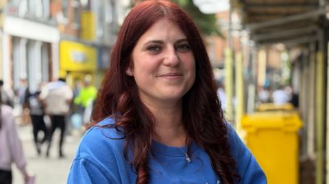 Chloe Hunter wearing a blue top and smiling