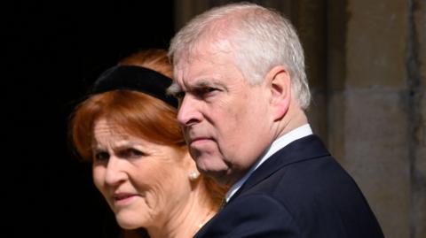 A file photo from the 2025 Easter Service at St George's Chapel in Windsor of the then-Prince Andrew, wearing a dark suit and pictured in a three-quarter view, with Sarah Ferguson, who has a black Alice band in her hair, standing behind him.