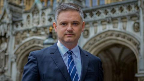 Lord Walney standing outside the Houses of Parliament