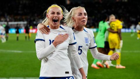 Chloe Maggie Kelly of England and Manchester City and Alex Greenwood of England and Manchester City celebrate victory on the pitch. Both are wearing their White England shirts 