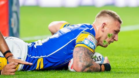 Mikolaj Oledzki diving down to score a try for Leeds Rhinos in their match with Leigh Leopards 