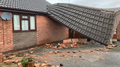 A home with part of the roof collapsed on the floor.