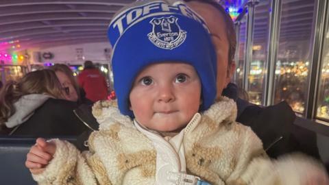Ronnie in fawn fleecy jacket and Everton bobble hat