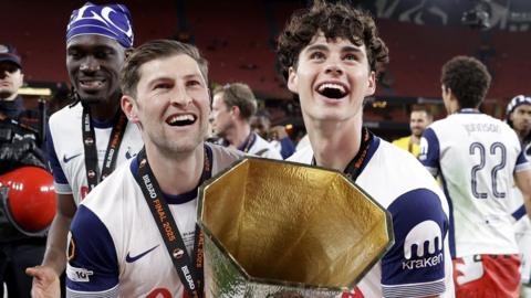 Tottenham's Ben Davies and Archie Gray lift the Europa League trophy